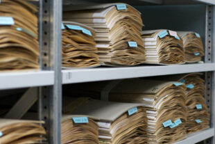 Neuchatel Herbarium pile of sample Wikimedia Commons