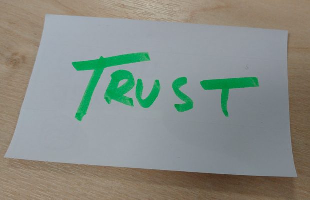 Trust in green pen on paper