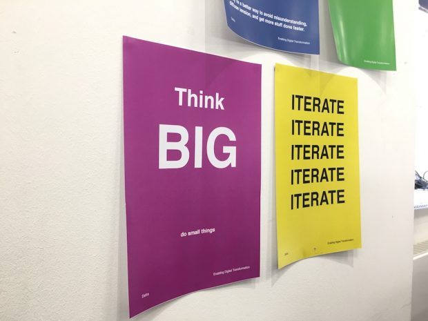 Poster saying "Think big, do small things" on the wall in the Defra office