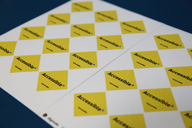 Rows of yellow diamond-shaped stickers with ‘Accessible’ printed in the middle. 