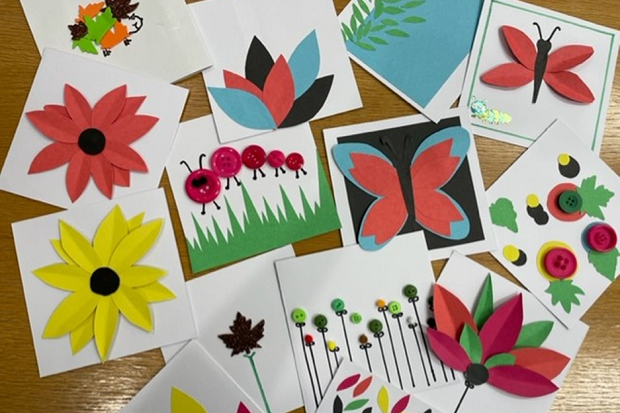 Brightly coloured cards spread out on a table. 