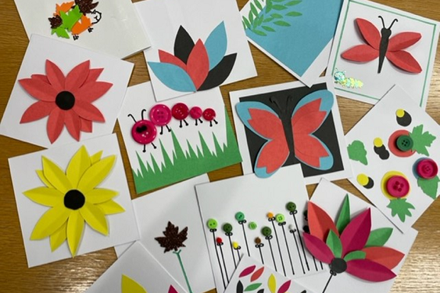 Brightly coloured cards spread out on a table.