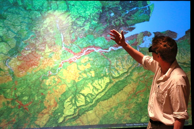 A person standing in front of a map.