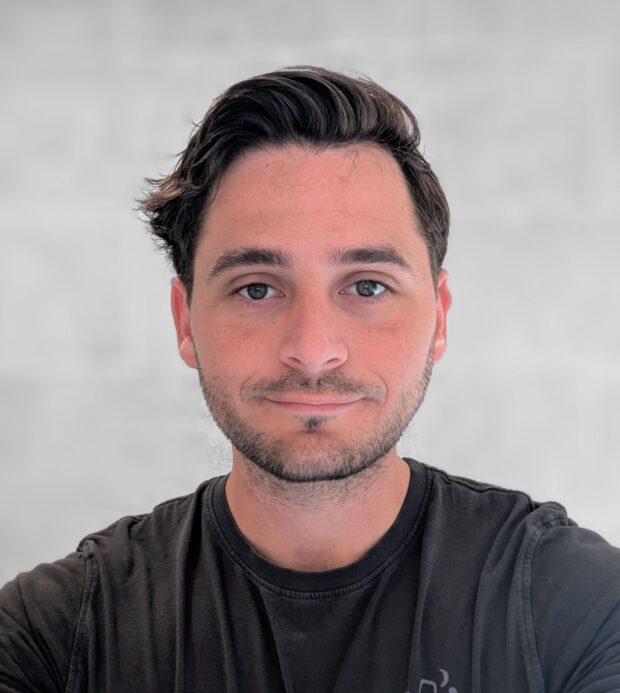 A headshot of Sam Brett
